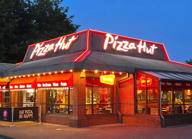 Image 4: Pizza Hut is temporarily rebranding as 'Hut' for 25 weeks to coincide with football season. (Photo by Peter Dazeley/Getty Images)
