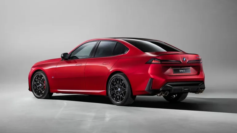rear three-quarter view, red sedan parked on gray studio background. rear three-quarter view, red sedan parked on gray studio background.