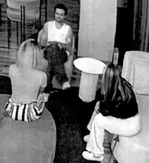Image 6: Liam in the lobby with two women (Argentina Police)