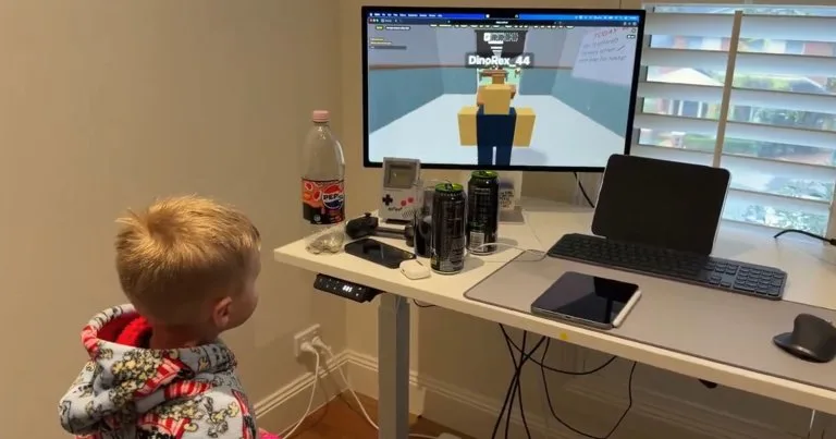 Image 12: A screenshot of a young boy playing a vibecoded version of Roblox.