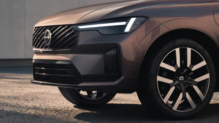 Image 10: Close-up of a modern car's front design, showcasing its grill, headlights, and sporty wheels.