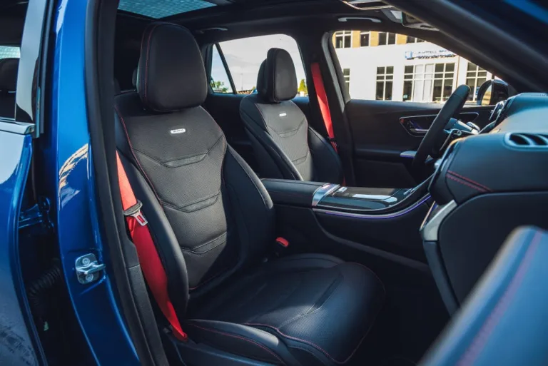 Interior view of a modern car featuring black and red sport seats and a sleek dashboard. Interior view of a modern car featuring black and red sport seats and a sleek dashboard.