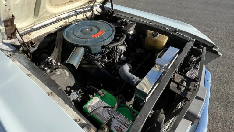 engine view. V8 engine bay with round air cleaner, aluminum radiator and open hood. engine view. V8 engine bay with round air cleaner, aluminum radiator and open hood.