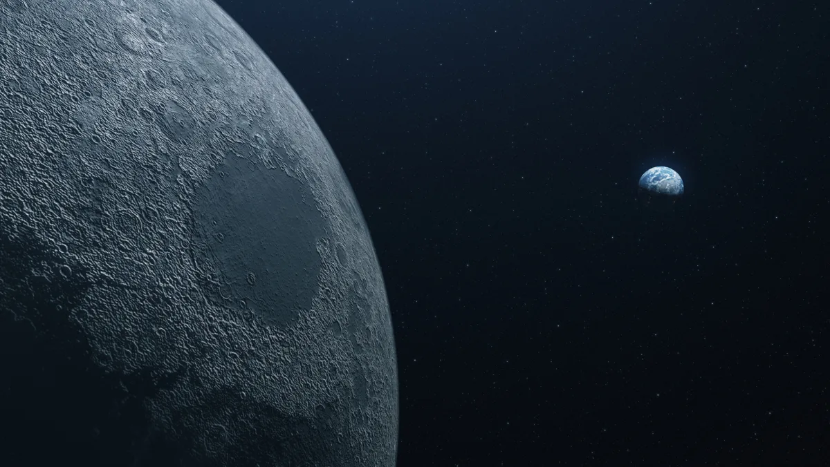 Image 41: A close up of the moon in space with the Earth farther back and to the right