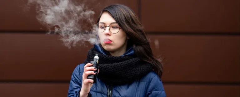Teenage girl vaping (AleksandrYu/Getty Images)