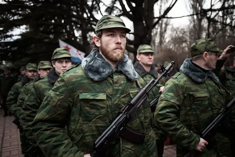 Image 7: Vladimir Putin called them 'self-defense' groups (Photo by RONNY ROMAN ROZENBERG / AFP via Getty Images)