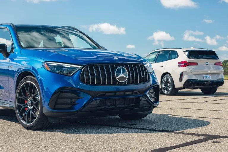A blue Mercedes-Benz SUV and a white BMW SUV parked side by side on a sunny day. A blue Mercedes-Benz SUV and a white BMW SUV parked side by side on a sunny day.