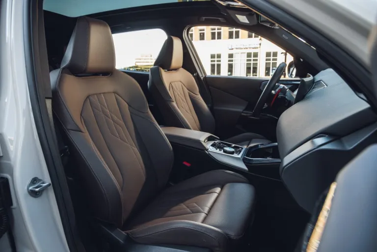 Luxurious interior of a car featuring modern front seats and a stylish center console. Luxurious interior of a car featuring modern front seats and a stylish center console.